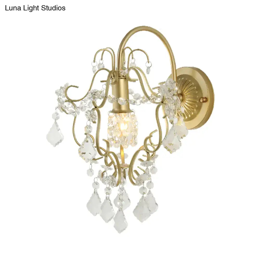 Gold crystal bent-arm wall sconce by Decorbites with hanging teardrop prisms on Tampa Home & Garden Store