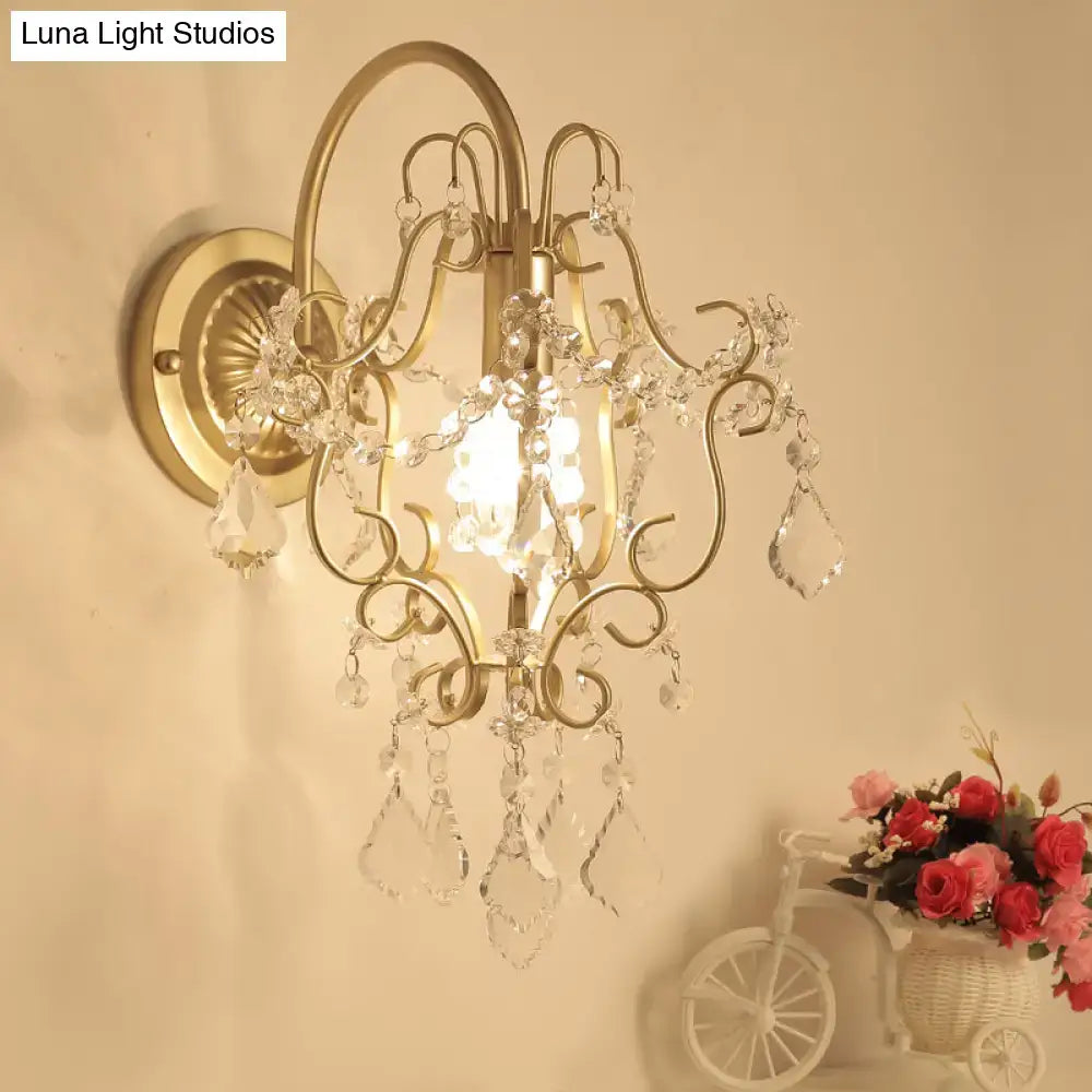Gold Crystal Bent Arm Sconce with crystal prisms and gold-tone frame, wall-mounted on Tampa Home & Garden Store