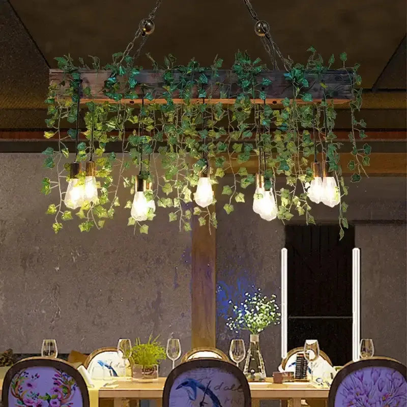 Rustic wood hanging chandeliers with Edison bulbs and ivy over dining table Decorbites on Tampa Home & Garden Store