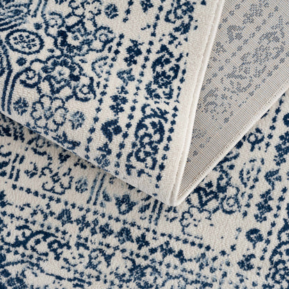 Michie Blue Area Rug cream navy floral pattern on stacked rugs on Tampa Home & Garden Store