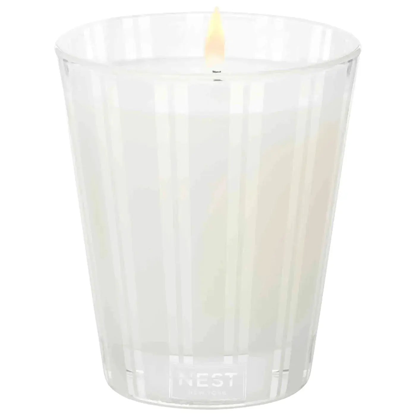 Nest New York Grapefruit Candle in a clear ribbed glass jar with a lit wick on Tampa Home & Garden Store