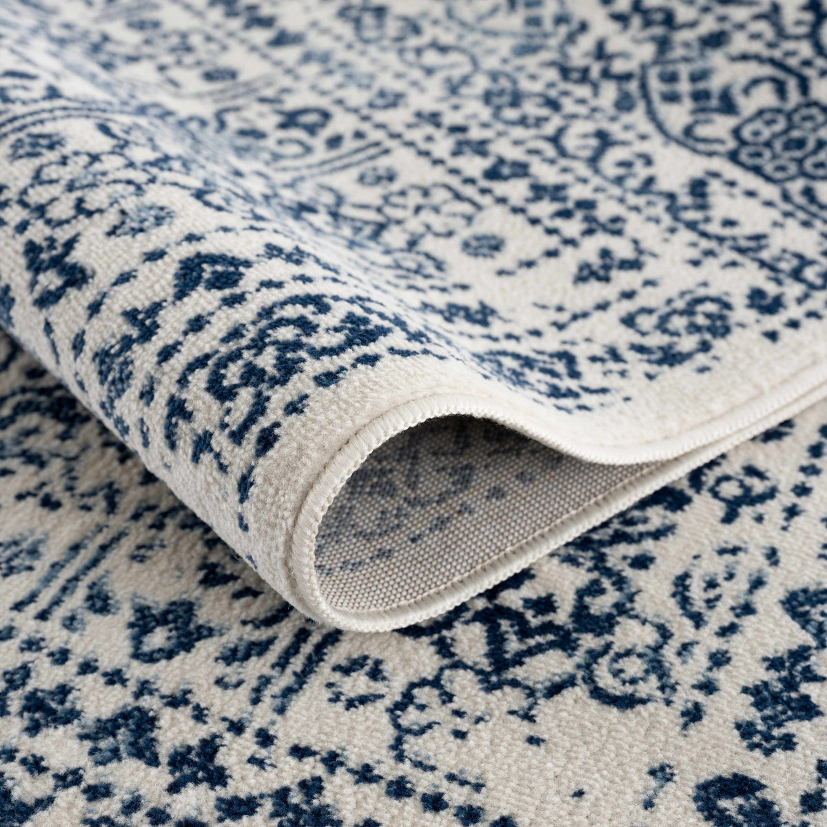Michie Blue Area Rug by Boutique Rugs closeup of blue ivory patterned textile on Tampa Home & Garden Store