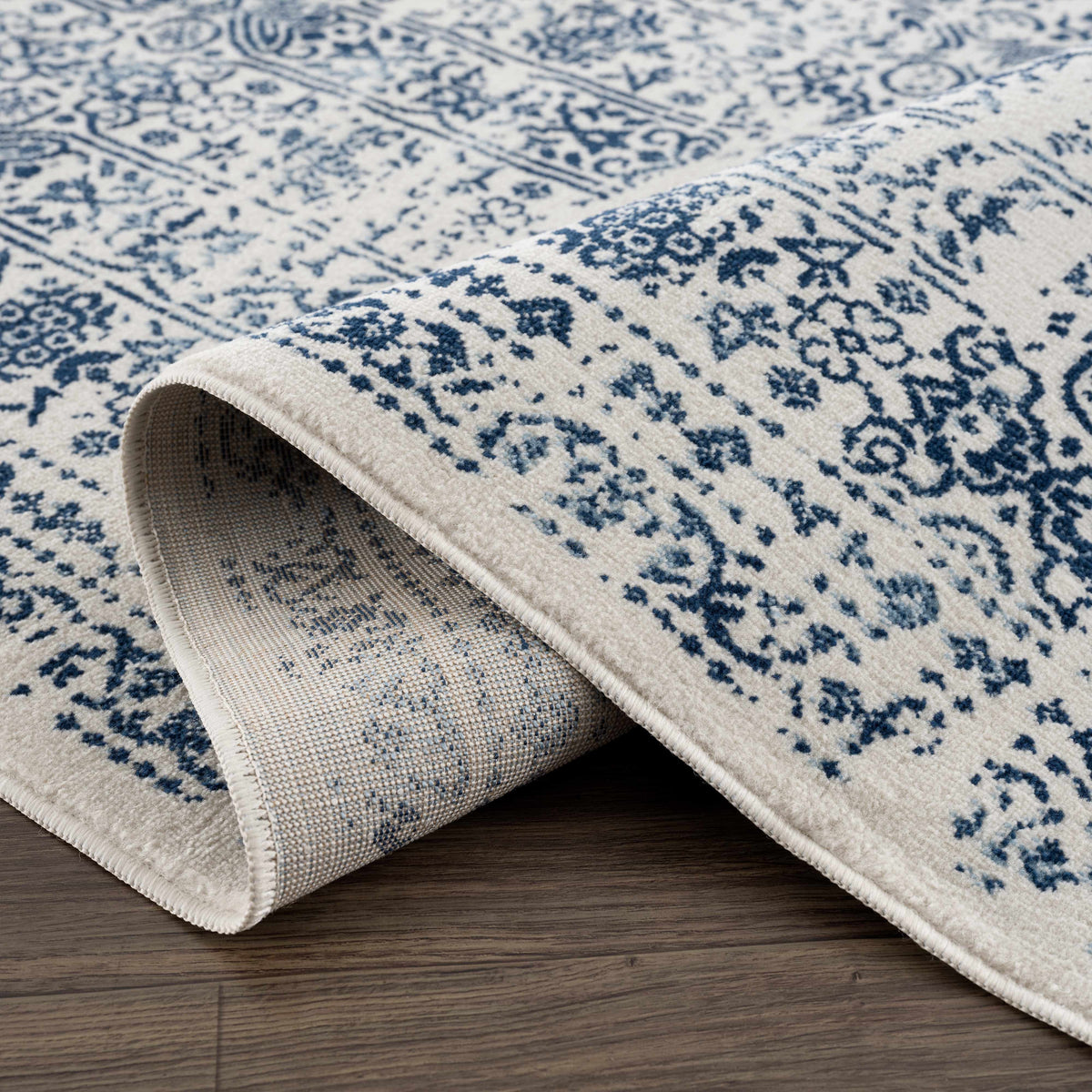 Michie Blue Area Rug by Boutique Rugs, blue ivory damask pattern, clearance, rolled edge view on Tampa Home & Garden Store