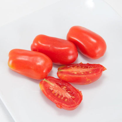San Marzano tomatoes, ripe red Roma-style fruits with cut halves on a white plate on Tampa Home & Garden Store