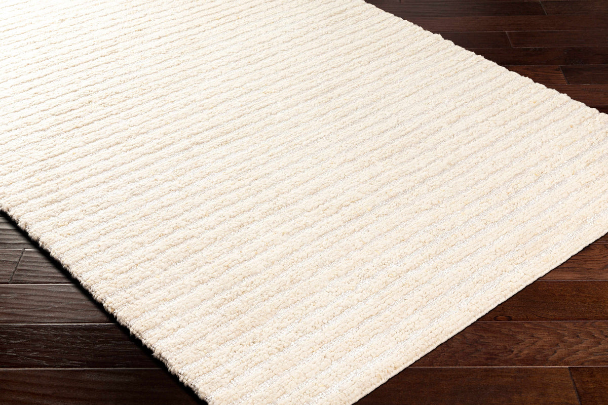 Debra area rug cream textured loop pile on dark hardwood floor on Tampa Home & Garden Store