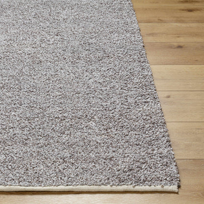 Kamil Gray Solid Area Rug by Boutique Rugs with plush shag texture on wood floor on Tampa Home & Garden Store