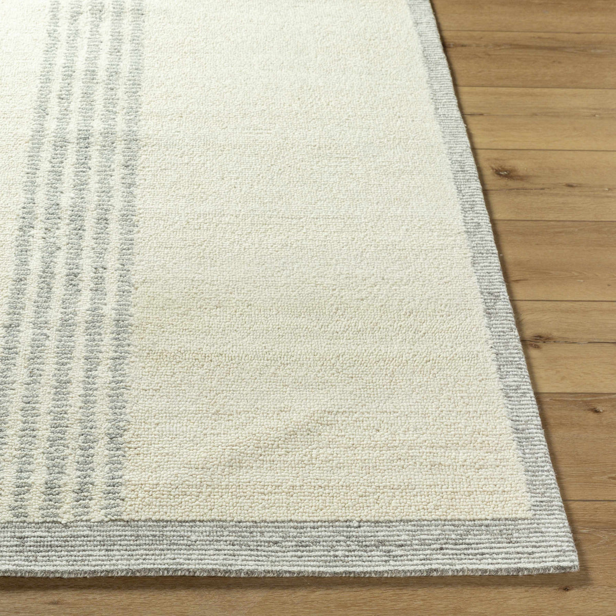Ande Cream Area Rug with gray striped border on Tampa Home & Garden Store
