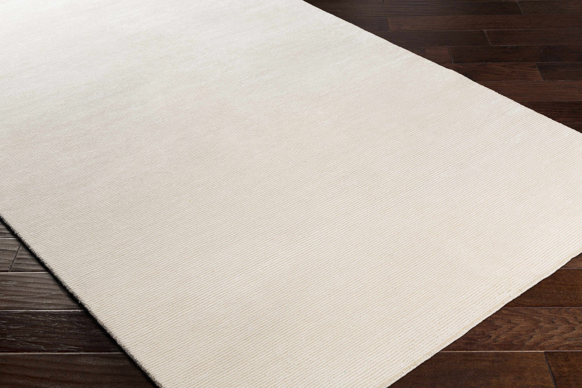 Sabinsville Carpet rug by Boutique Rugs, beige with diagonal rib texture on dark wood floor on Tampa Home & Garden Store