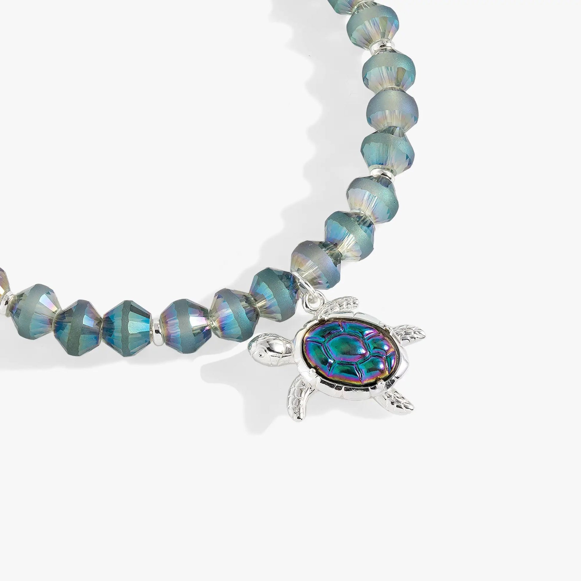 Sea Turtle Beaded Bangle bracelet with iridescent blue-teal beads and a silver turtle charm on Tampa Home & Garden Store