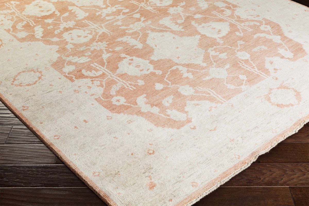 Seney Peach Area Rug by Boutique Rugs, peach & ivory abstract pattern with fringe on wood floor on Tampa Home & Garden Store