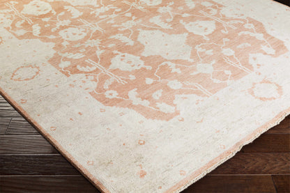 Seney Peach Area Rug by Boutique Rugs, peach & ivory abstract pattern with fringe on wood floor on Tampa Home & Garden Store