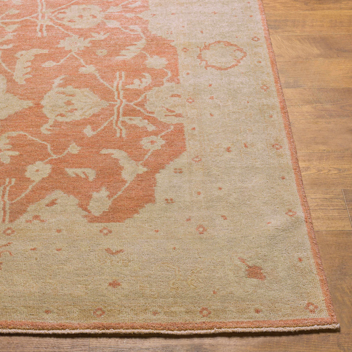 Seney Peach area rug by Boutique Rugs in peach and cream with a faded pattern on wood floor on Tampa Home & Garden Store
