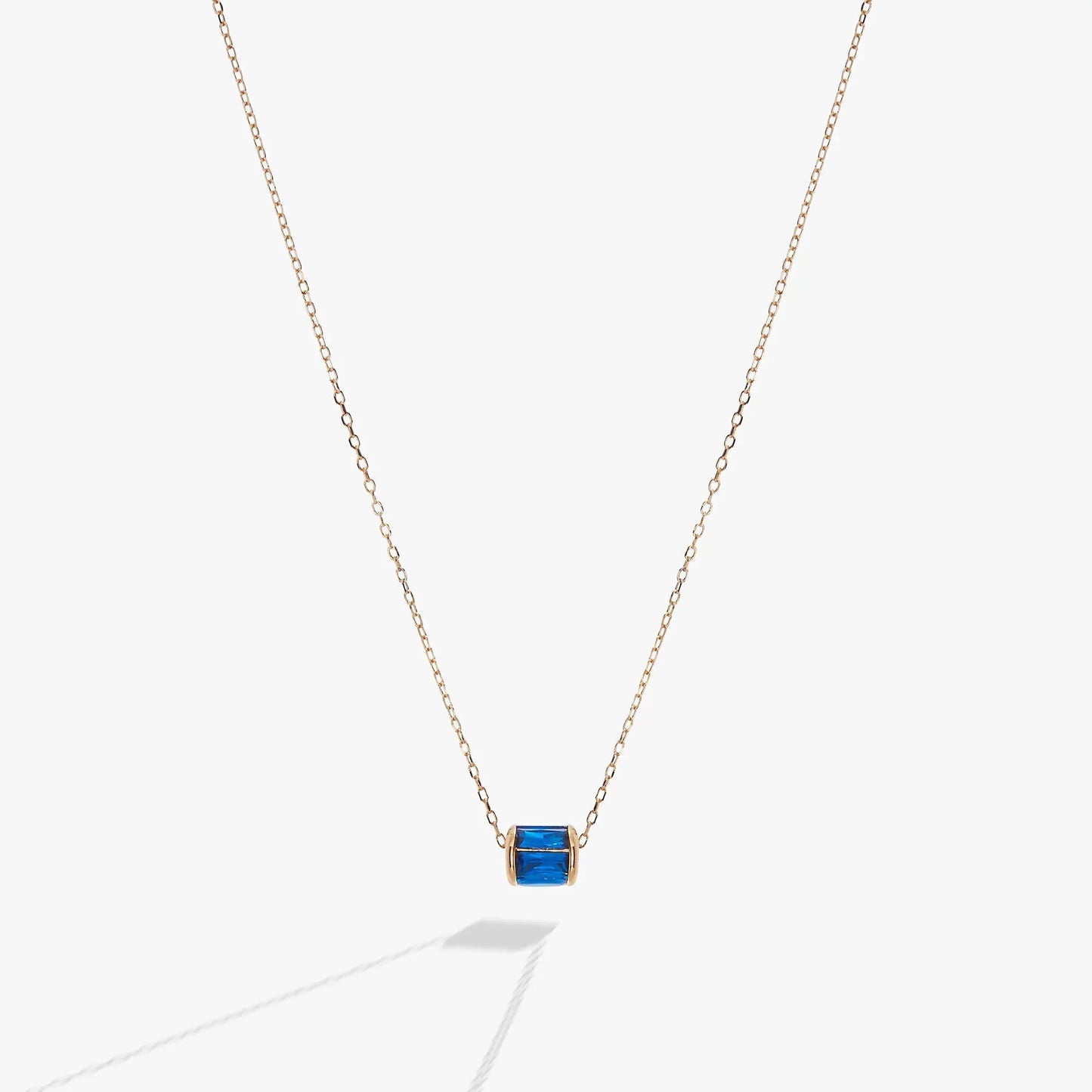 September Birthstone Pendant Necklace with blue stone in gold bezel on rose gold chain on Tampa Home & Garden Store