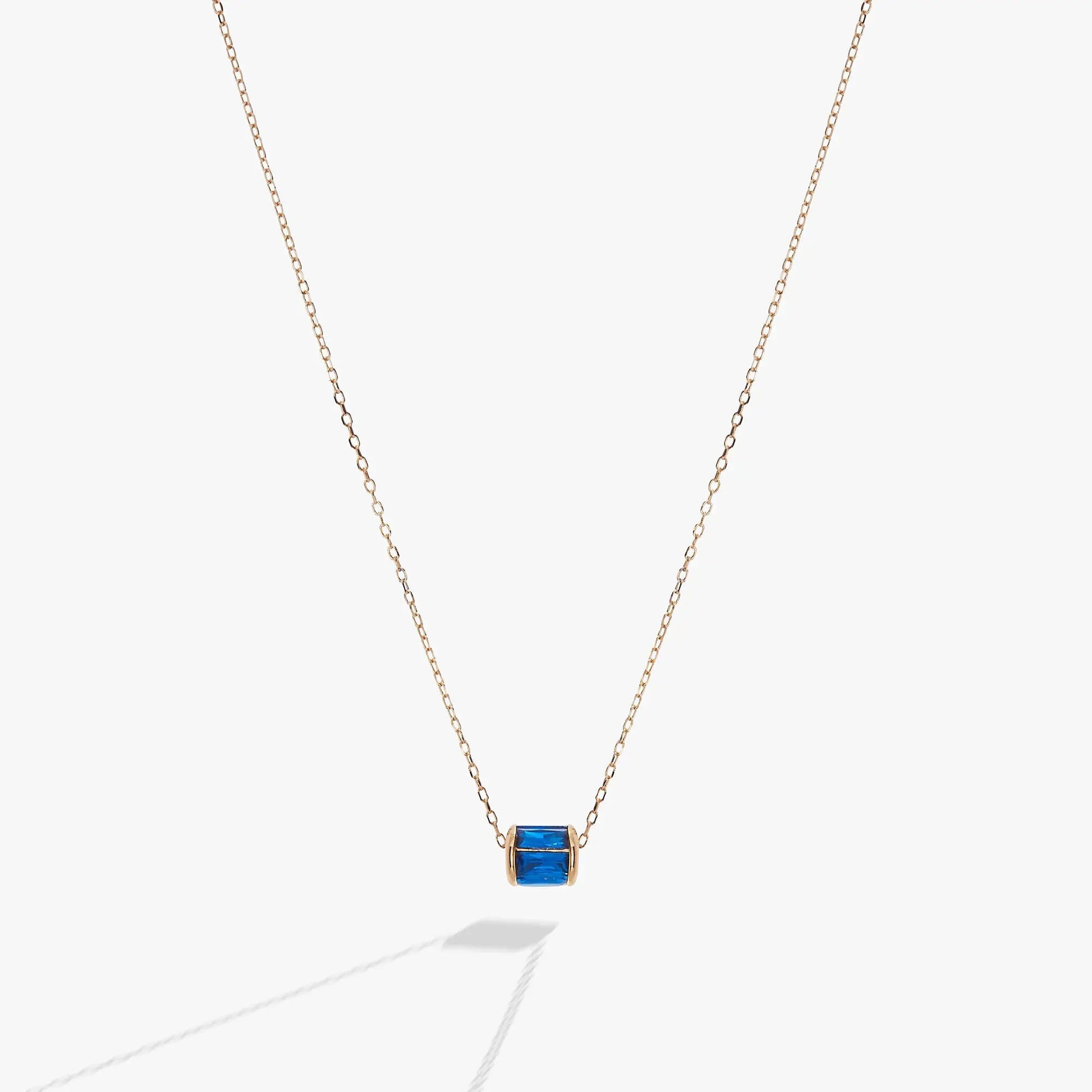 September Birthstone Pendant Necklace with blue stone in gold bezel on rose gold chain on Tampa Home & Garden Store