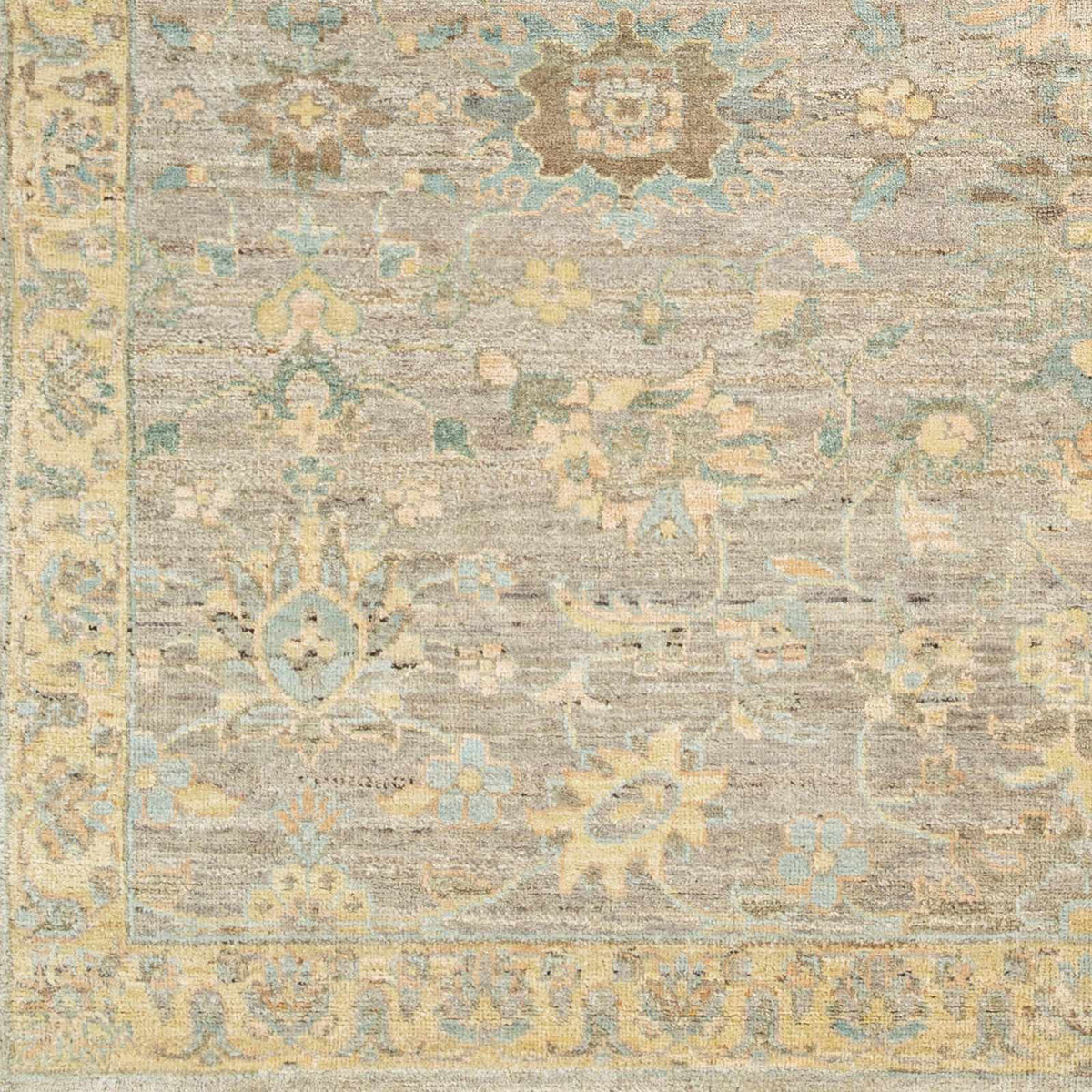Cream Afia Area Rug by Boutique Rugs in distressed beige with blue and yellow floral motifs on Tampa Home & Garden Store