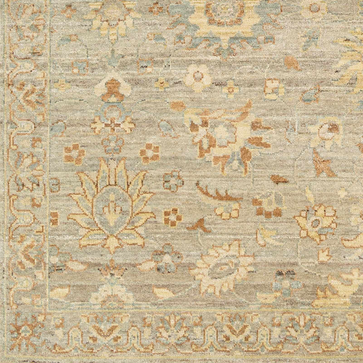 Tan Afia area rug by Boutique Rugs in beige with blue accents and floral border on Tampa Home & Garden Store