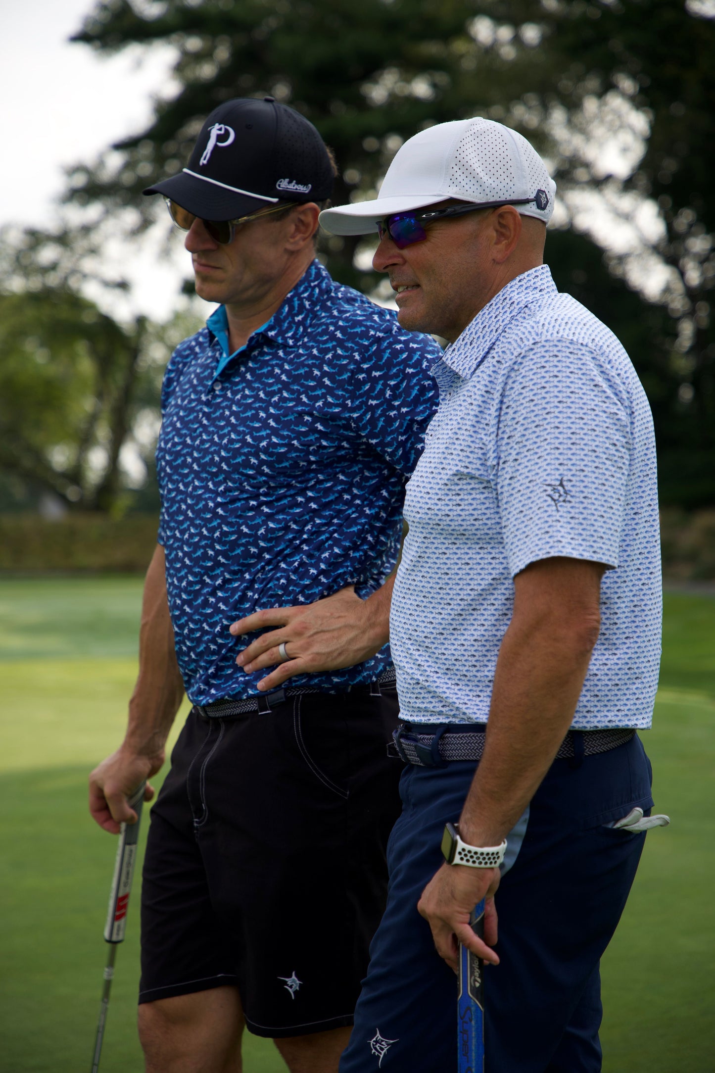 Sharks Polo shirts by White Water Life, blue shark-print polos for men, two shown on course on Tampa Home & Garden Store