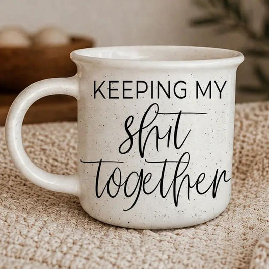 Shit Together coffee mug by Gia Roma, white speckled ceramic with black script lettering on Tampa Home & Garden Store