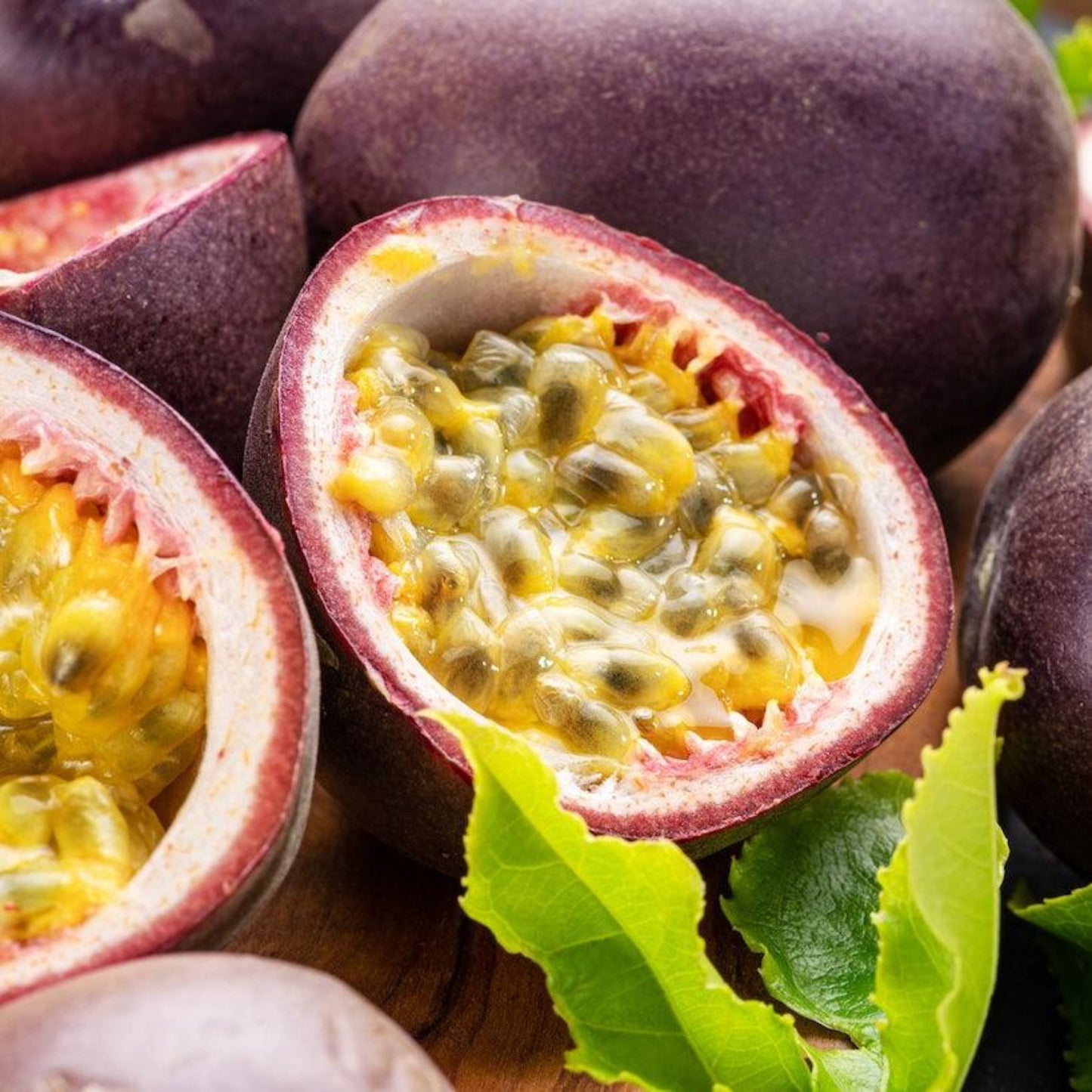 Passion fruit halves with purple rind and yellow pulp, bright green leaves on Tampa Home & Garden Store