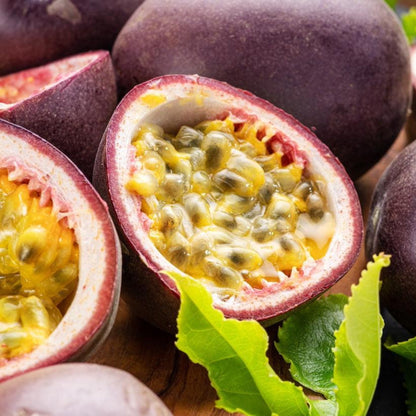 Passion fruit halves with purple rind and yellow pulp, bright green leaves on Tampa Home & Garden Store
