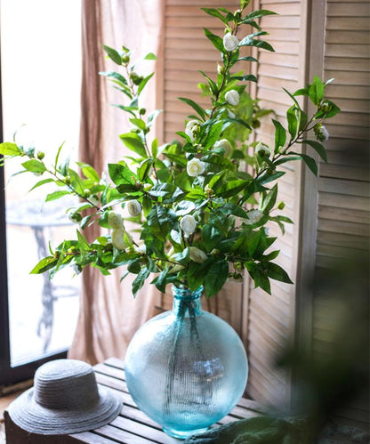 Faux silk camellia stem with green leaves and white blooms in a blue glass vase RusticReach on Tampa Home & Garden Store