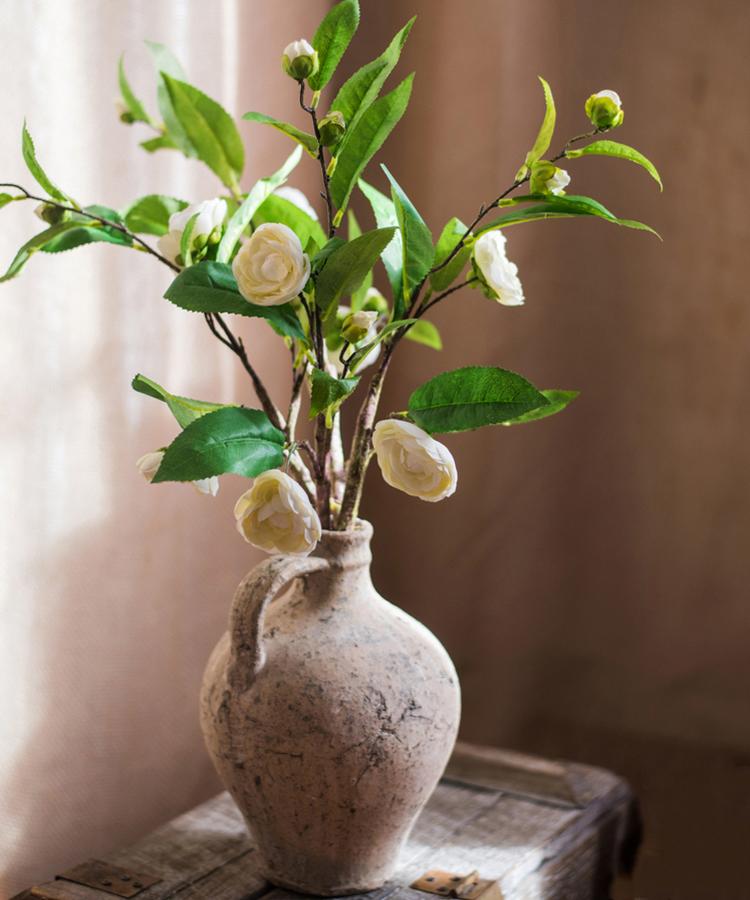 Faux Silk Camellia Stem with white blooms and green leaves by RusticReach in a rustic vase on Tampa Home & Garden Store