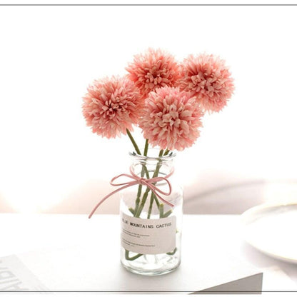 Stevvex silk flower bouquet with 4 pink pom-pom blooms in a glass bottle vase on Tampa Home & Garden Store