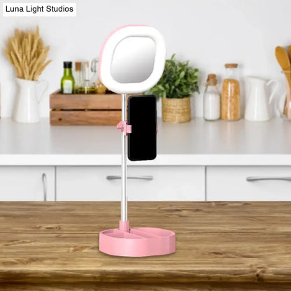 Light Blue LED Vanity Light ring on a silver stand with pink phone clamp from Decorbites on Tampa Home & Garden Store
