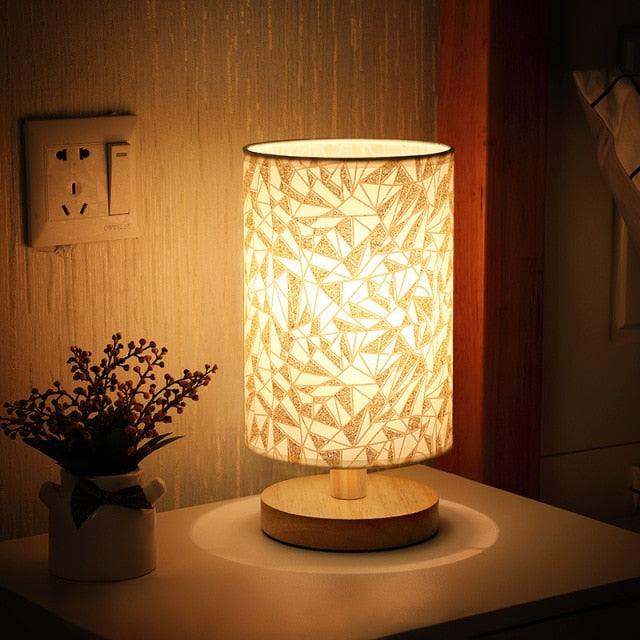 Stevvex table lamp with solid wood base and geometric patterned shade emitting warm light on Tampa Home & Garden Store