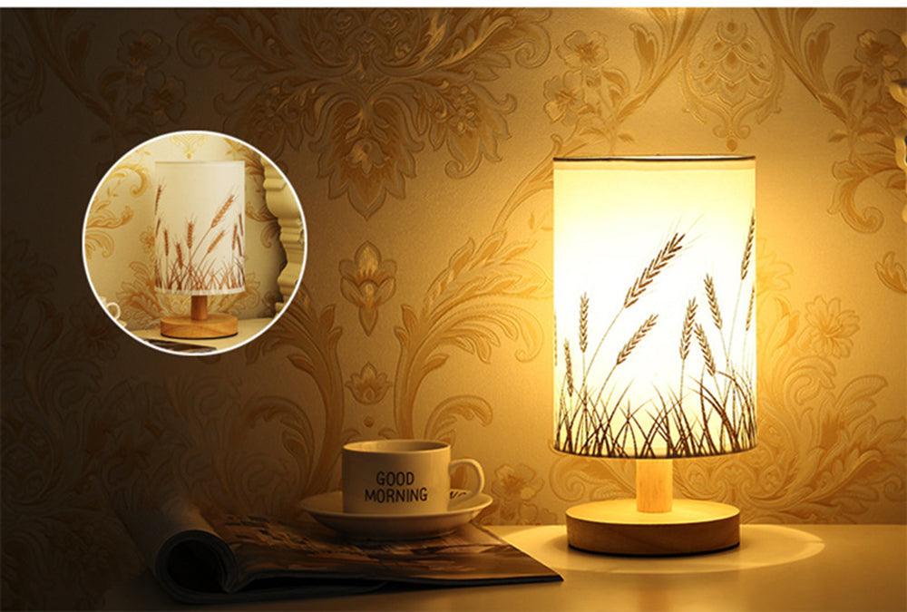 Simple Modern table lamp with solid wood base and wheat design lampshade emitting warm glow on Tampa Home & Garden Store