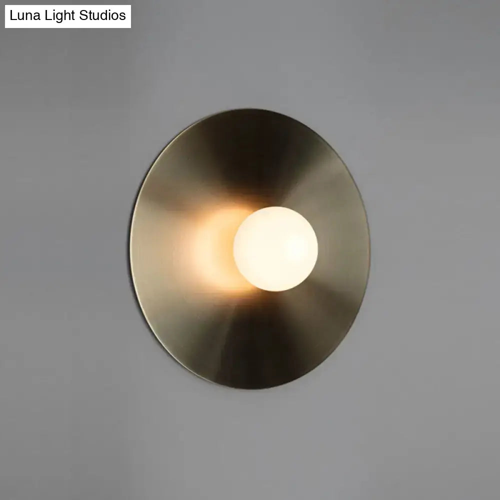 Brushed brass wall sconce with round backplate and frosted globe bulb Decorbites on Tampa Home & Garden Store