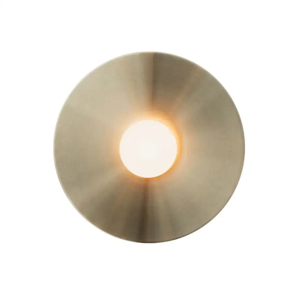 Brushed Brass Wall Sconce with round backplate and warm glow on Tampa Home & Garden Store