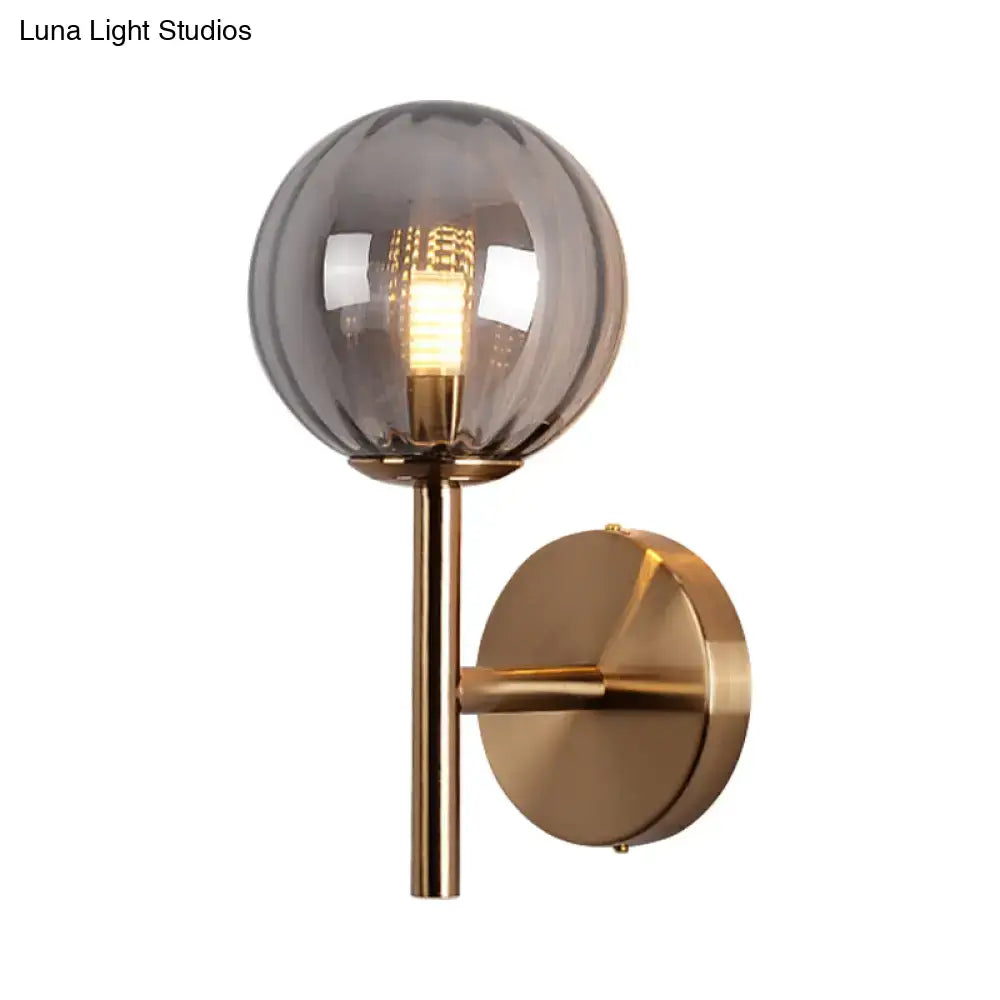 Decorbites amber glass globe wall sconce with brass mount on Tampa Home & Garden Store