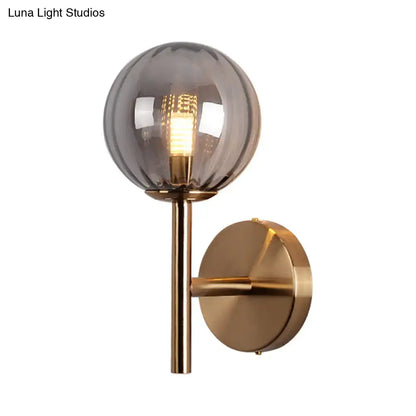 Decorbites amber glass globe wall sconce with brass mount on Tampa Home & Garden Store