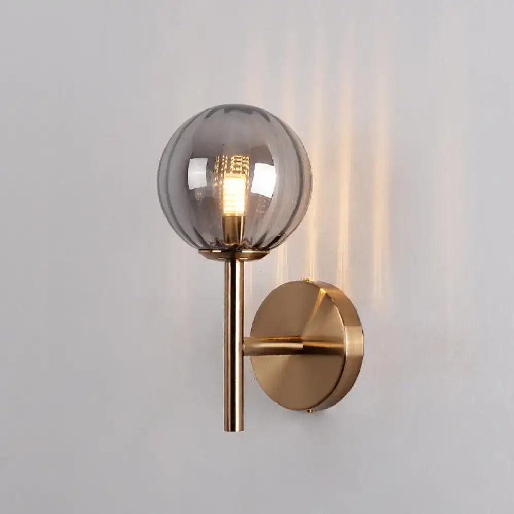 Amber glass wall sconce by Decorbites with brass finish and smoky glass globe wall mount on Tampa Home & Garden Store