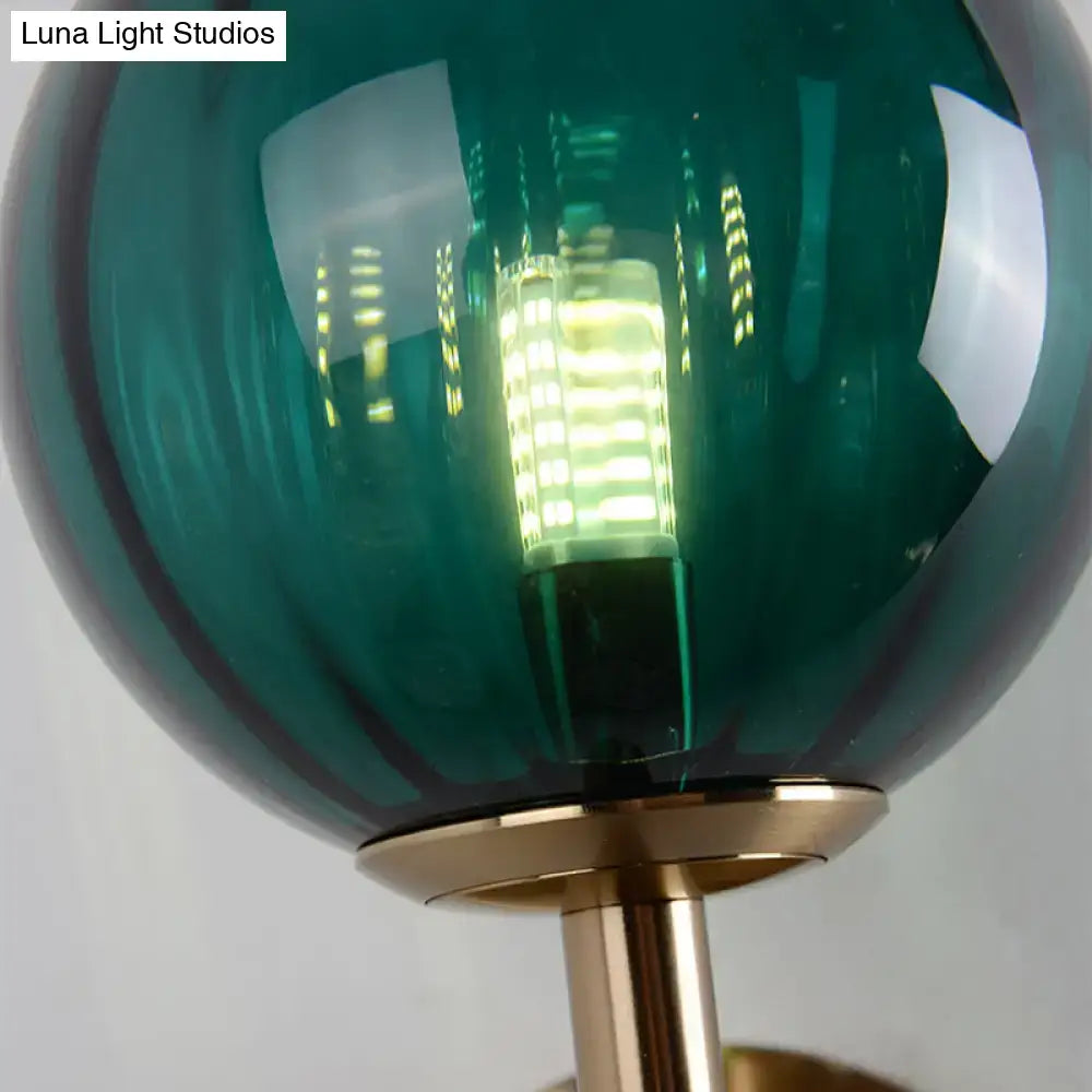 Decorbites green glass wall sconce with brass mount and LED filament globe on Tampa Home & Garden Store