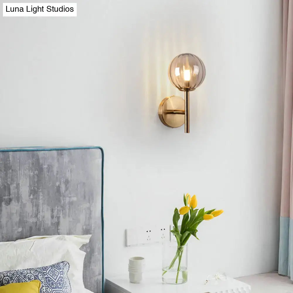 Amber glass wall sconce with round globe shade and brass hardware by Decorbites on Tampa Home & Garden Store