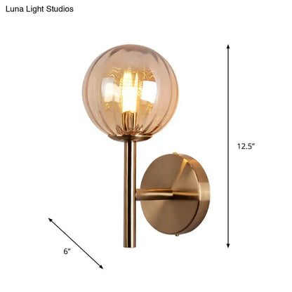 Amber glass globe wall sconce by Decorbites, brass finish with filament bulb, 12.5in tall on Tampa Home & Garden Store