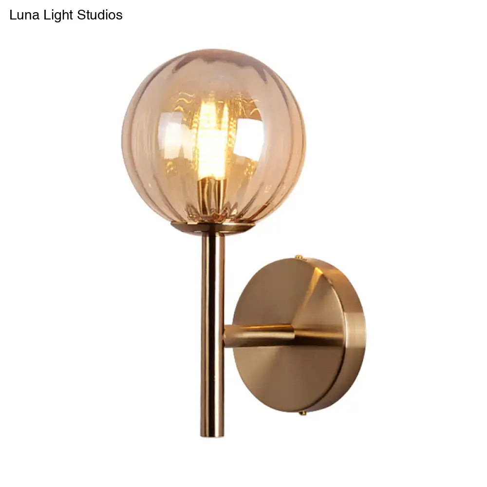 Amber glass globe wall sconce with brass finish by Decorbites on Tampa Home & Garden Store
