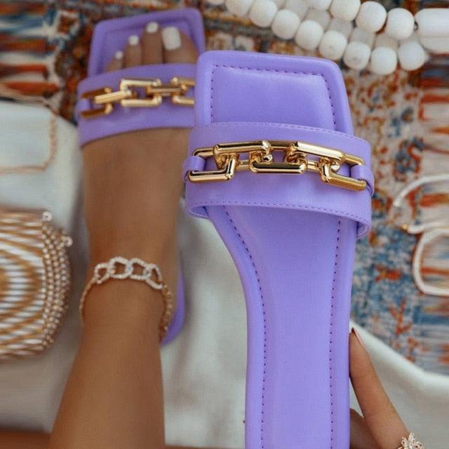 Purple open-toe slide sandals with a gold chain accent on the strap casual flat footwear on Tampa Home & Garden Store