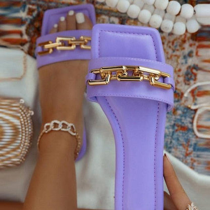 Purple open-toe slide sandals with a gold chain accent on the strap casual flat footwear on Tampa Home & Garden Store