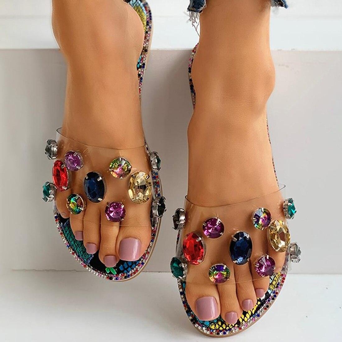 Pair of women’s open-toe rhinestone slide sandals with clear straps and multicolor gems on Tampa Home & Garden Store