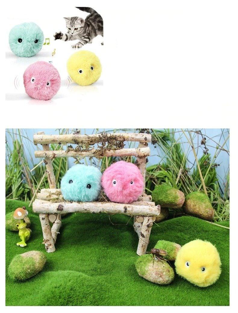 Interactive pom-pom cat toy balls Stevvex turquoise pink yellow with squeaky chirps on a bench on Tampa Home & Garden Store