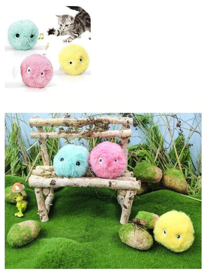 Interactive pom-pom cat toy balls Stevvex turquoise pink yellow with squeaky chirps on a bench on Tampa Home & Garden Store
