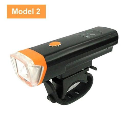 Stevvex bicycle front light Model 2 with black body and orange front, mounted on a strap on Tampa Home & Garden Store