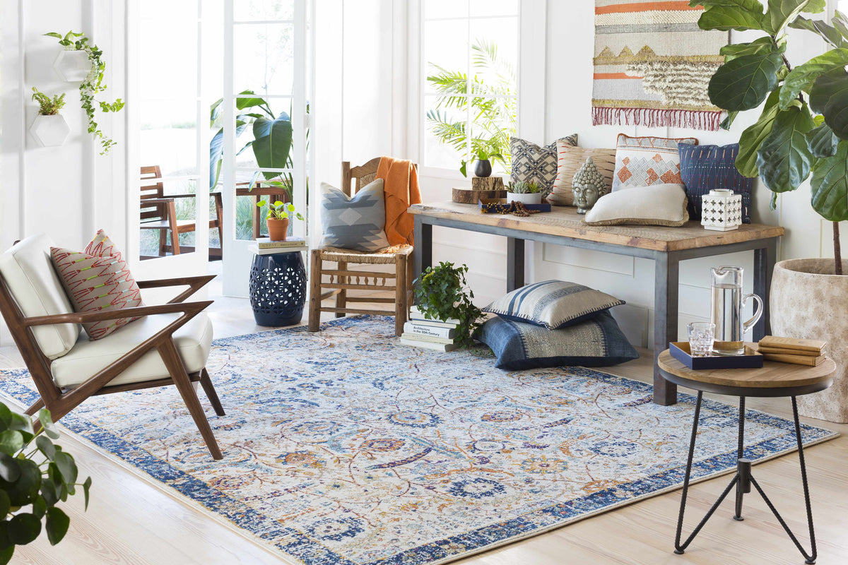 Smyrna Area Rug by Boutique Rugs, cream field with blue and orange geometric floral motif on Tampa Home & Garden Store