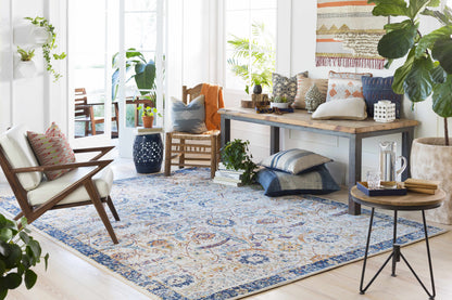 Smyrna Area Rug by Boutique Rugs, cream field with blue and orange geometric floral motif on Tampa Home & Garden Store