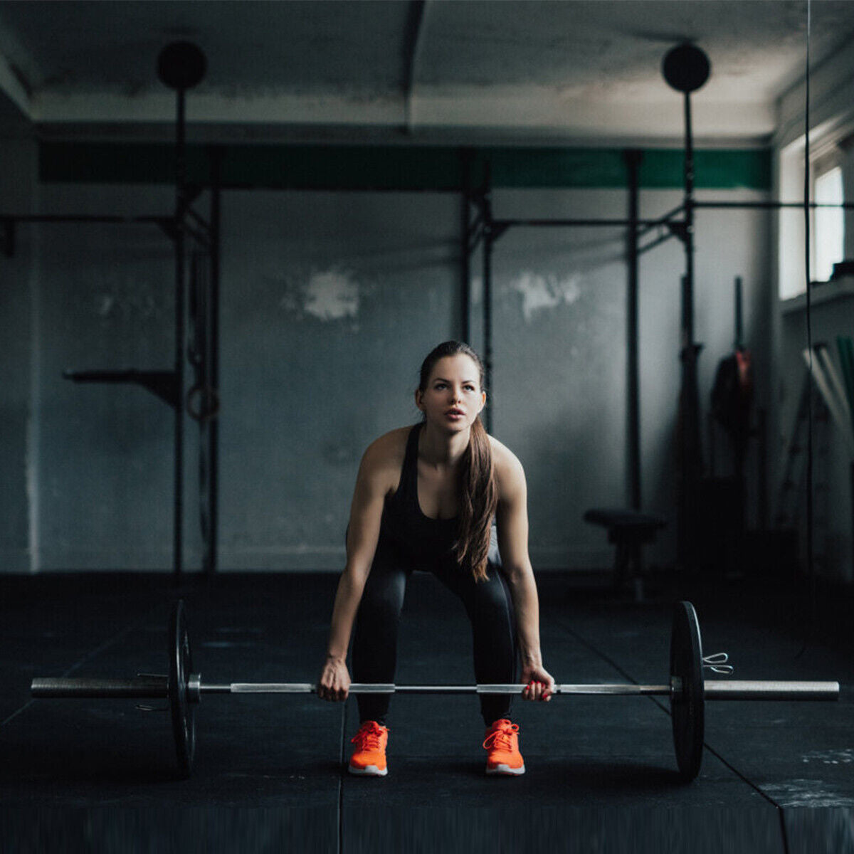 1000 lbs Weight Lifting Barbell gym floor; woman in black wear ready to lift, orange shoes on Tampa Home & Garden Store