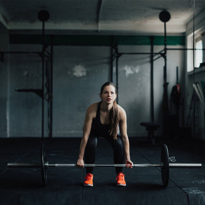 1000 lbs Weight Lifting Barbell gym floor; woman in black wear ready to lift, orange shoes on Tampa Home & Garden Store