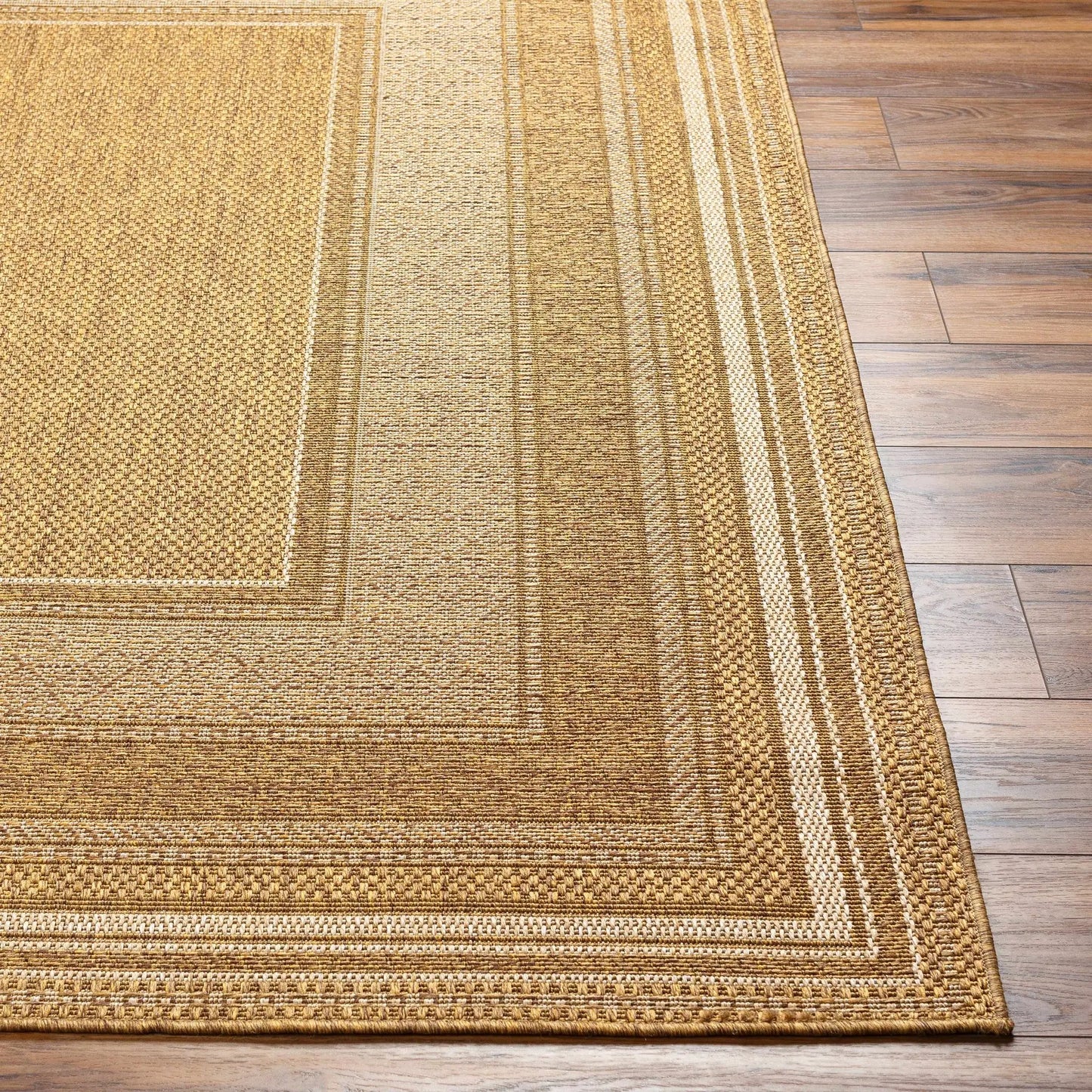 Chael flatweave faux jute outdoor rug in warm brown with textured weave and border on Tampa Home & Garden Store